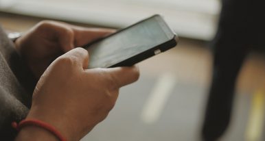 Person holding phone, close up of hands.