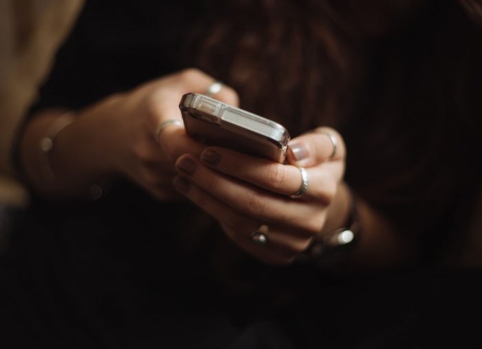 Woman Holding phone, close up of hands